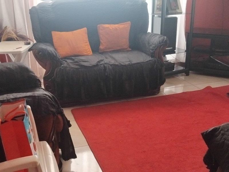 A living room area featuring tiled flooring, providing a functional space for relaxation and entertainment.