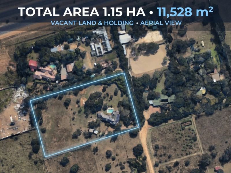 Aerial view of a 1.15-hectare small holding property featuring a main dwelling, swimming pool, and expansive grounds.