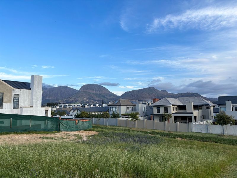 A scenic view of the surrounding residential estate and mountain range from the vacant residential land.