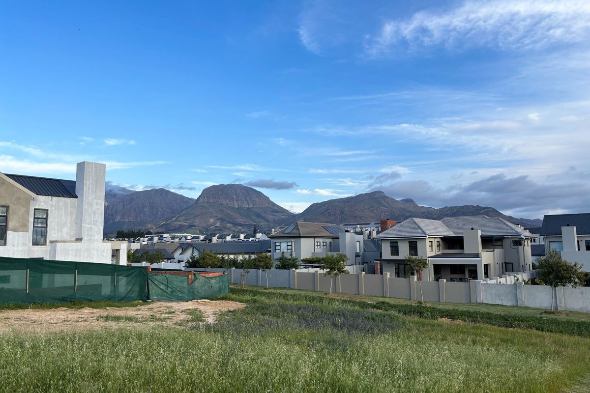 A scenic view of the surrounding residential estate and mountain range from the vacant residential land.