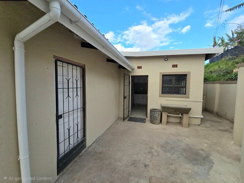 Rear exterior area featuring a concrete wash basin, security gates, and functional guttering system.