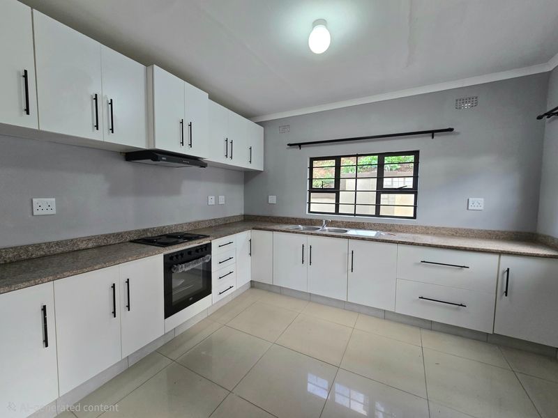 Modern kitchen featuring white cabinetry, stone countertops, built-in oven, hob, extractor fan, and tiled flooring in a clean, well-maintained space.
