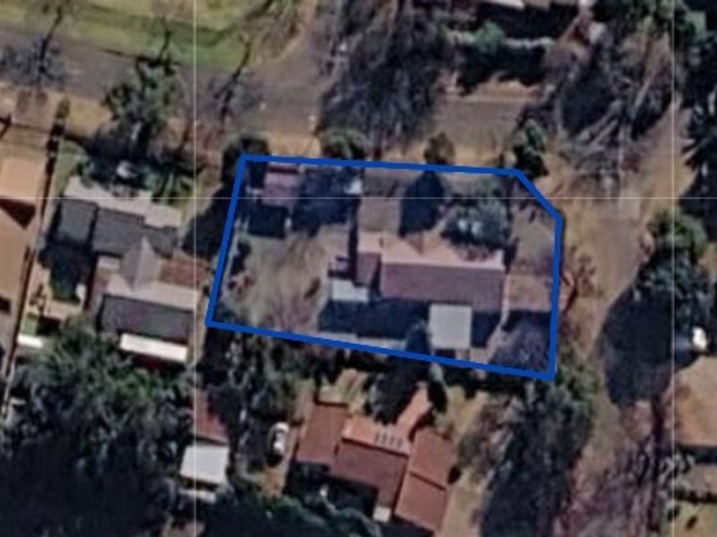 An aerial satellite view showing the property boundary and surrounding residential neighborhood layout.