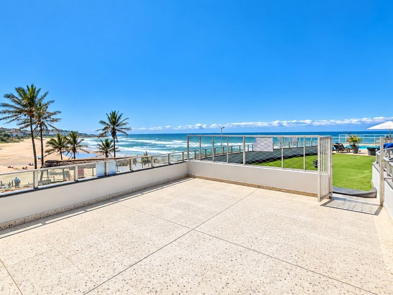 Spacious outdoor balcony featuring terrazzo flooring, metal balustrades, and panoramic ocean views, providing an ideal space for relaxation and entertainment.