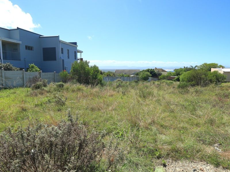 A vacant residential plot of land featuring established boundary walls and surrounding neighborhood views, ideal for new construction.