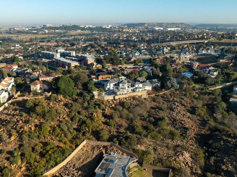 Aerial view of the property situated within a residential estate, showcasing the surrounding landscape and neighborhood context.
