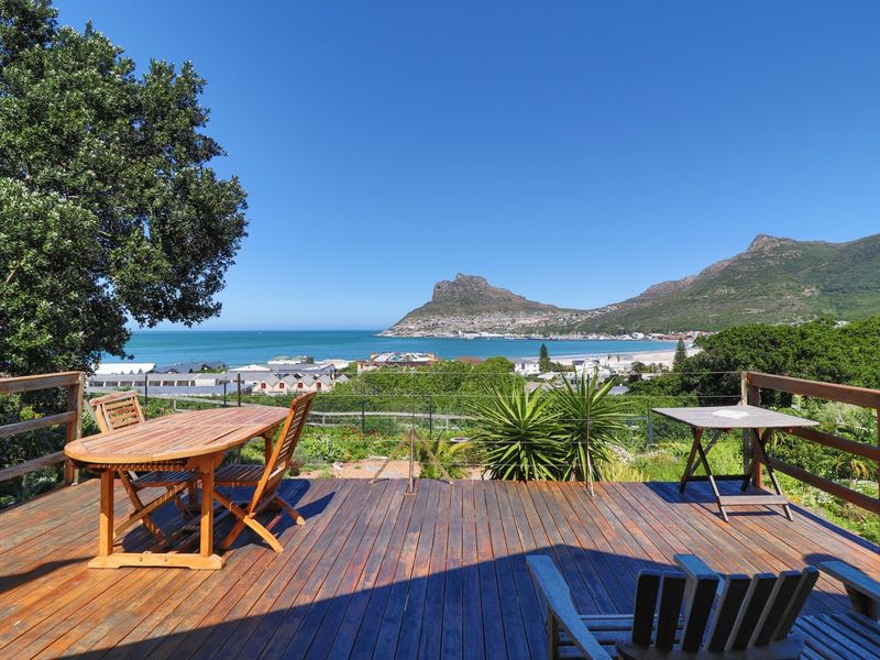 Spacious timber deck offering panoramic coastal and mountain views, providing an ideal outdoor space for relaxation and entertaining.