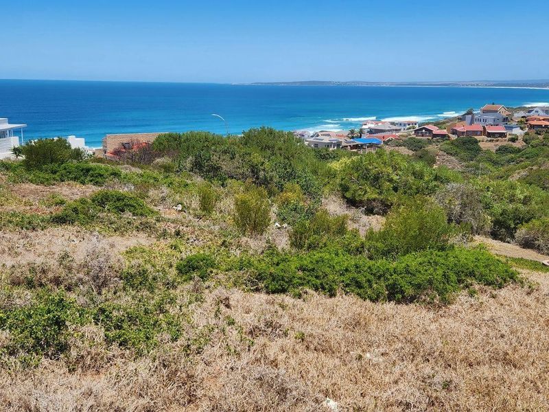 A scenic elevated view overlooking the coastal landscape, surrounding residential properties, and the ocean horizon.