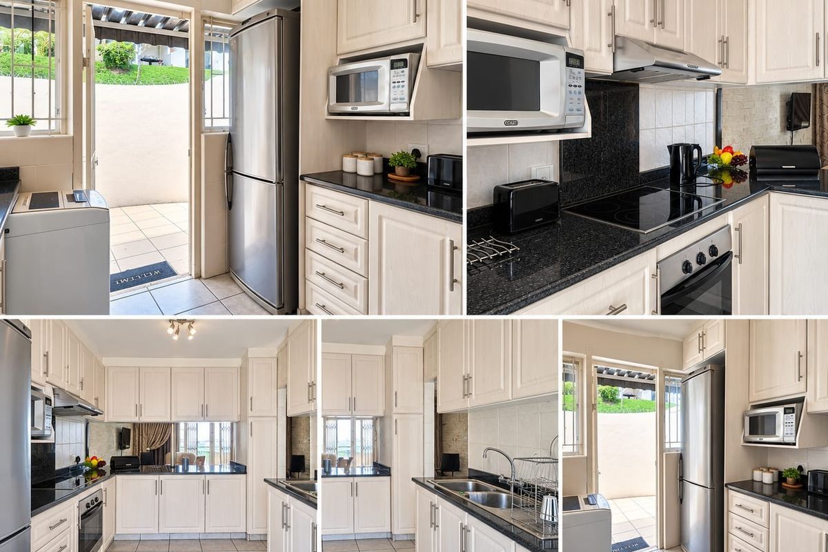 A well-appointed kitchen featuring light-toned cabinetry, granite countertops, integrated appliances, and direct access to an outdoor patio area.