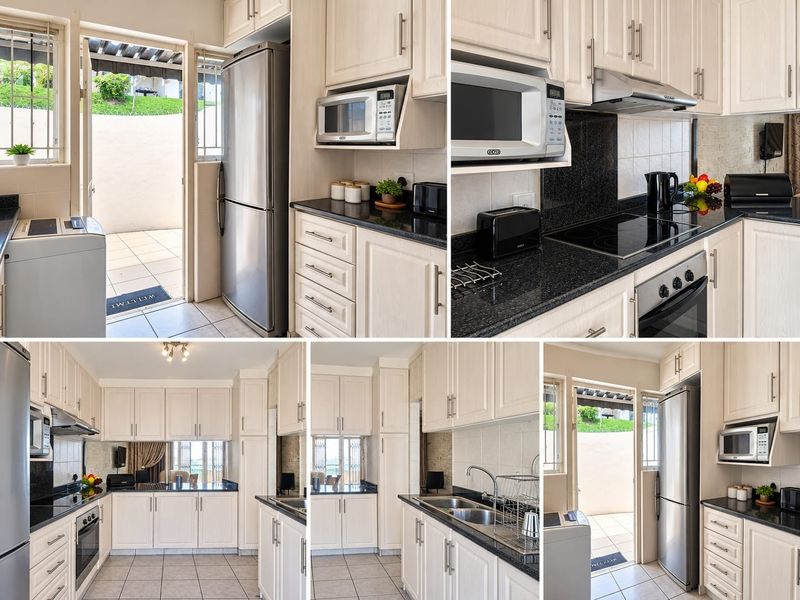 A well-appointed kitchen featuring light-toned cabinetry, granite countertops, integrated appliances, and direct access to an outdoor patio area.