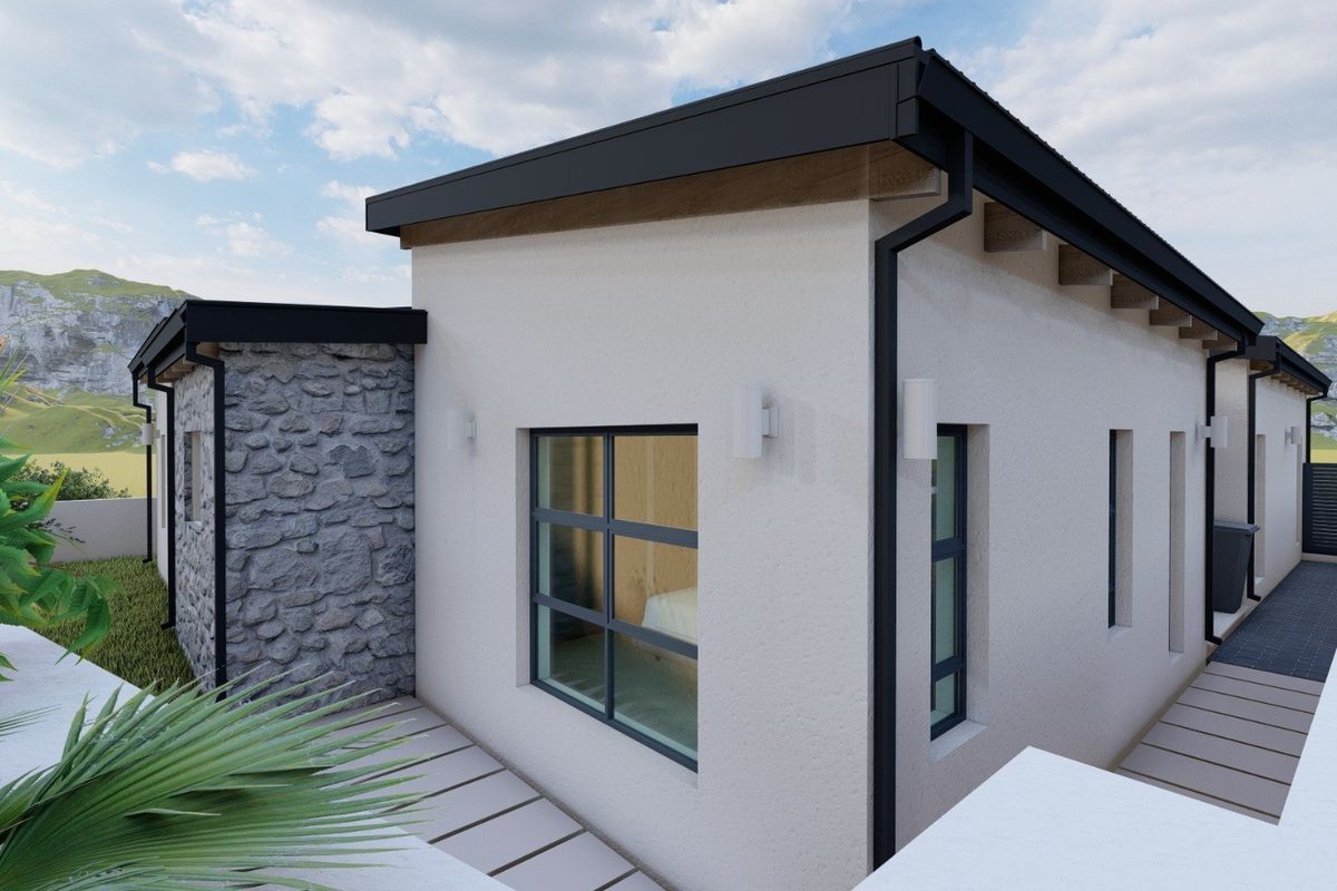 A modern residential exterior featuring stone cladding, black metal window frames, and clean architectural lines set against a scenic landscape.