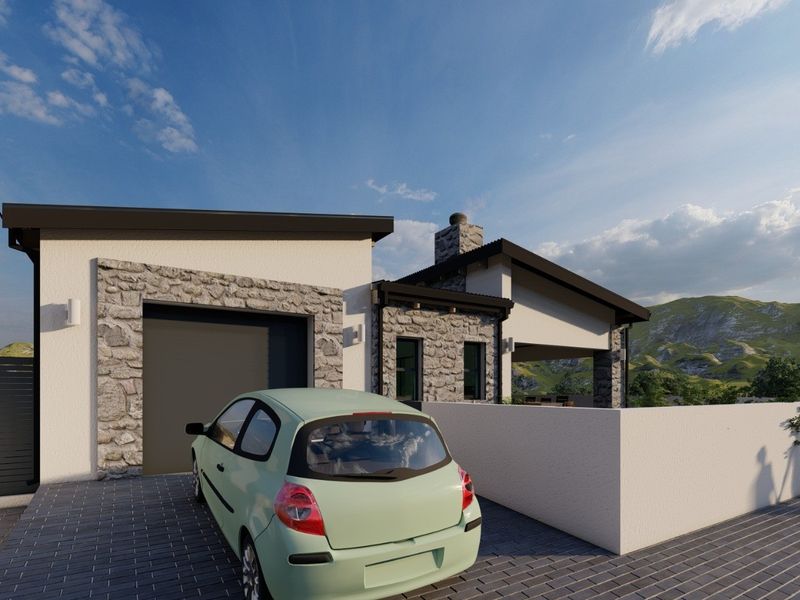 A modern residential exterior featuring stone cladding, a paved driveway, and a garage, set against a scenic mountain backdrop.