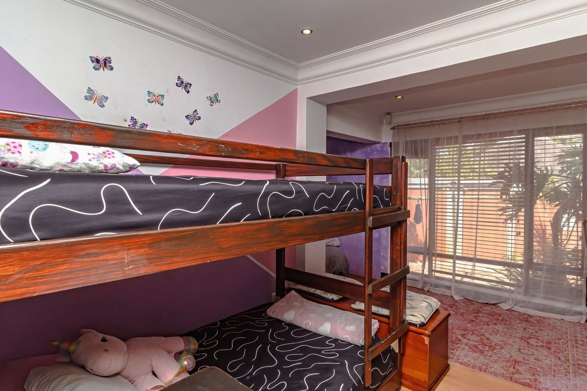 A bedroom featuring crown molding, recessed lighting, and a sliding glass door providing access to the exterior.