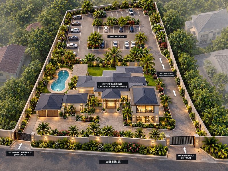 Aerial view of a professionally landscaped property featuring a swimming pool, extensive paved parking area, and secure gated access from the street.
