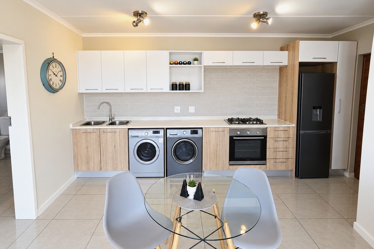Modern kitchen featuring light wood and white cabinetry, gas hob, electric oven, integrated sink, and tiled flooring in a clean, well-maintained space.