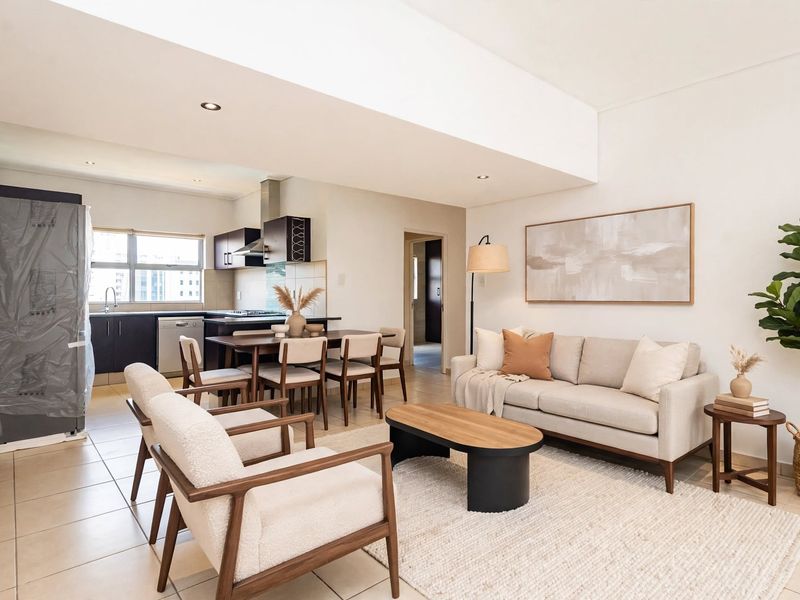 Spacious open-plan living and dining area featuring tiled floors, recessed lighting, and a modern kitchen with built-in cabinetry and integrated appliances.