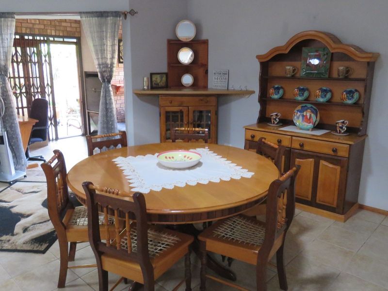 A dining room area featuring tiled flooring and a sliding door leading to an outdoor space.
