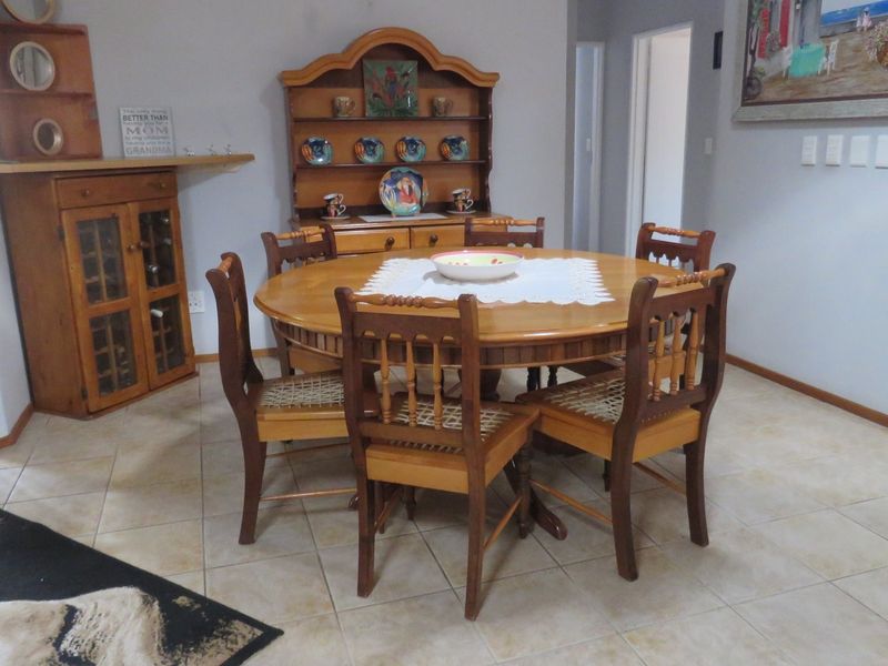 A dining room featuring tiled flooring and built-in wooden cabinetry, providing a functional space for family meals.
