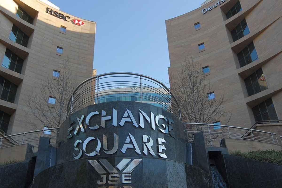 Exterior view of the Exchange Square commercial building featuring a prominent stone water feature, modern curved architecture, and corporate signage.