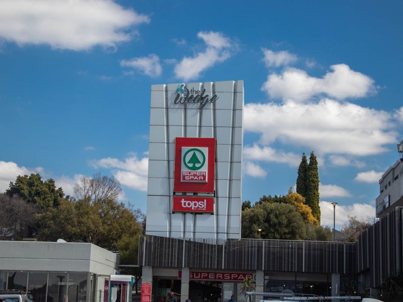Front exterior view of The Wedge commercial center featuring prominent pylon signage and retail branding.