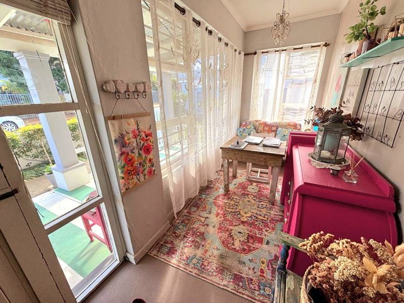 A sun-filled enclosed patio or sunroom featuring large windows, natural light, and direct access to the exterior.