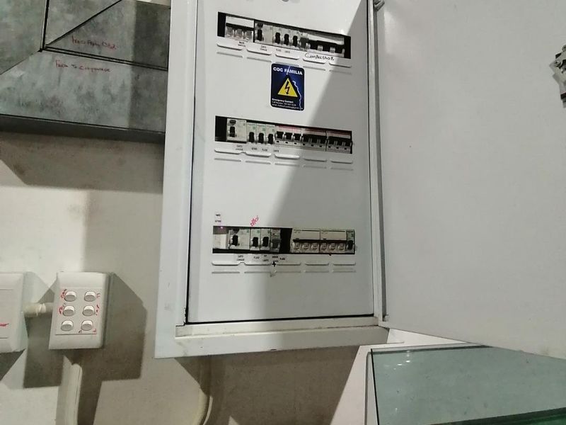 A wall-mounted electrical distribution board with multiple circuit breakers, providing essential power management infrastructure for the industrial property.