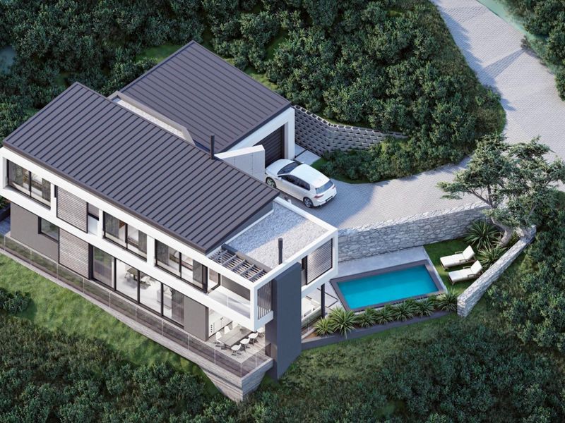 Aerial view of a modern multi-level residence featuring a swimming pool, paved driveway, and contemporary architectural design set within a landscaped environment.