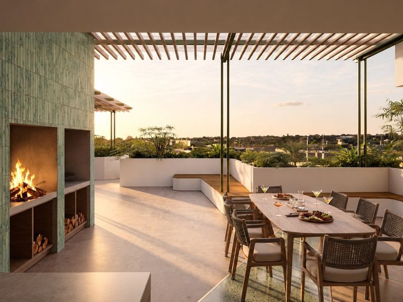 A luxurious outdoor patio featuring a built-in fireplace, pergola, and integrated bench seating, offering a perfect space for alfresco dining and relaxation.