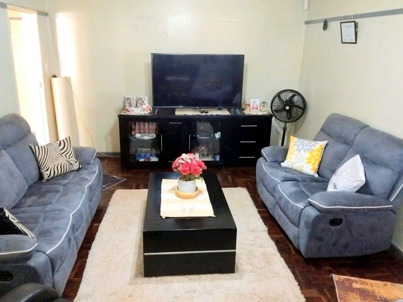 A cozy living room featuring classic parquet flooring, providing a warm and traditional foundation for the space.