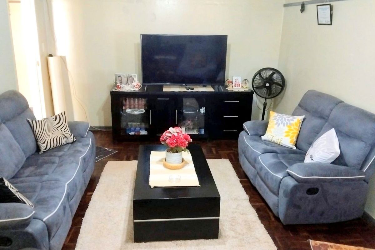A cozy living room featuring classic parquet flooring, providing a warm and traditional foundation for the space.