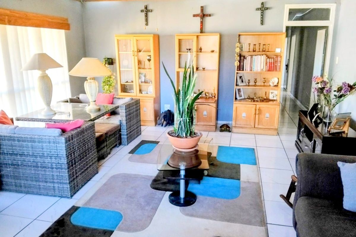 Spacious living area featuring tiled flooring, timber ceiling, and built-in wooden cabinetry, offering a functional layout for relaxation and storage.