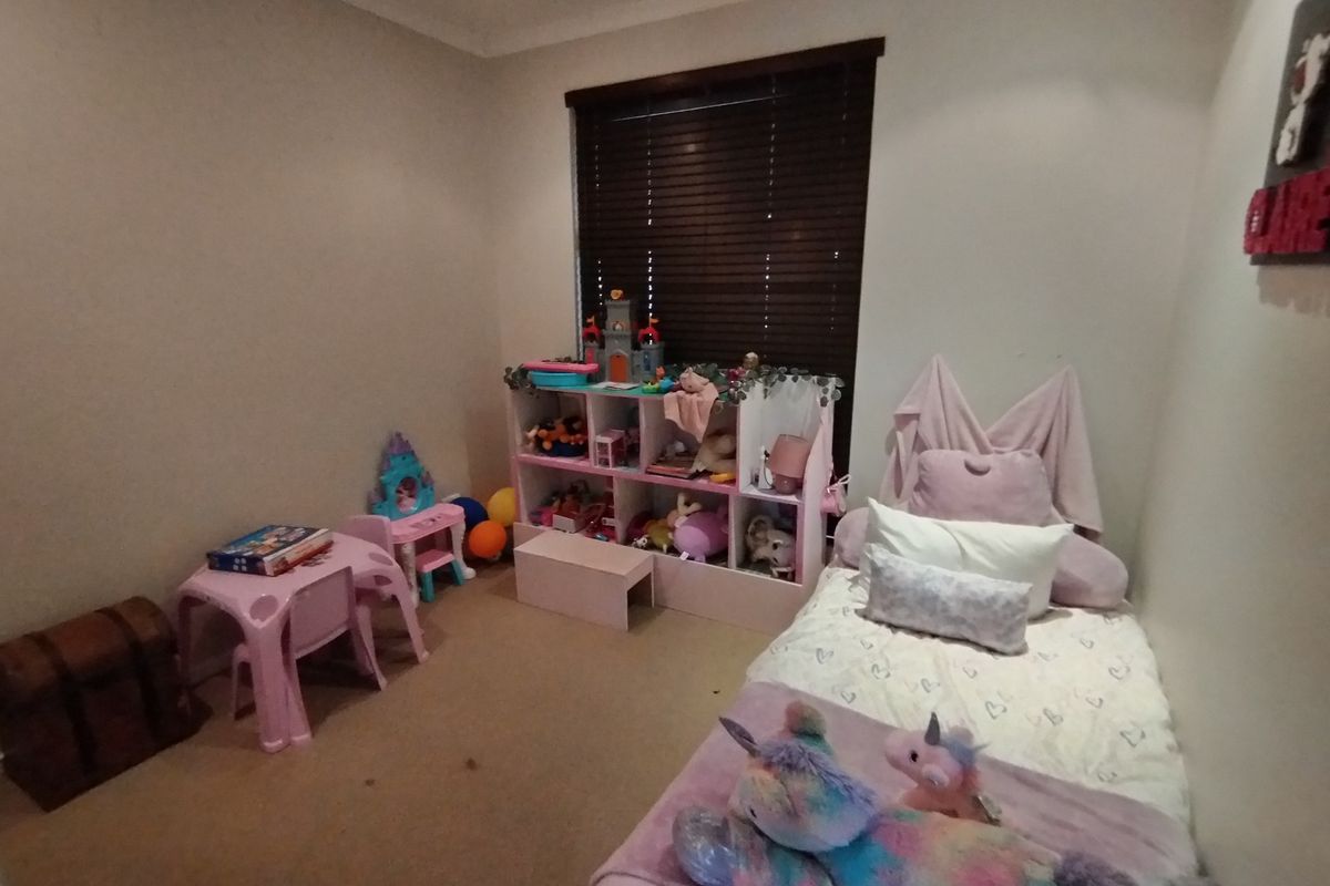 A bedroom featuring carpet flooring, recessed downlights, and venetian blinds on the window.