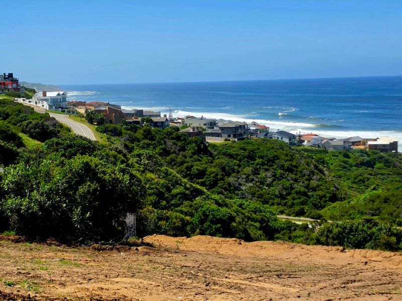 A scenic elevated view overlooking the coastline, ocean, and surrounding residential neighborhood.