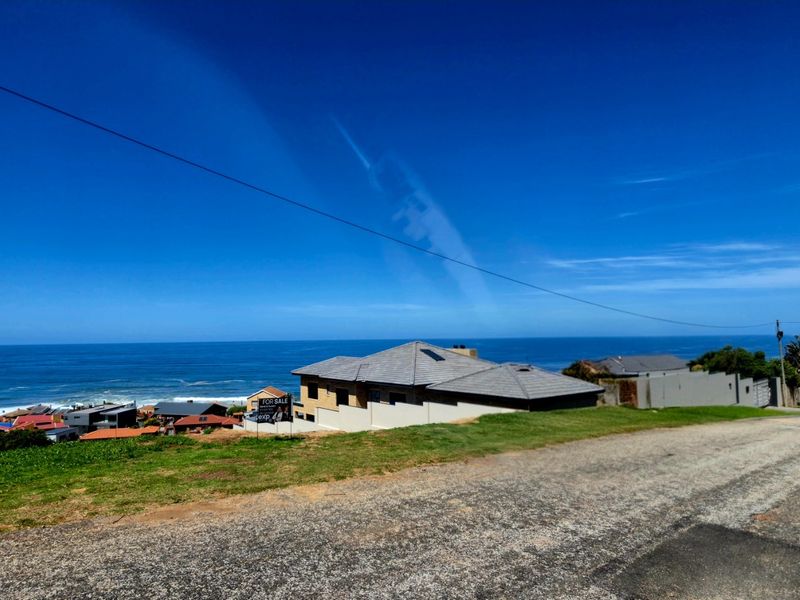 A scenic elevated view overlooking the coastline and ocean, showcasing the property's prime location and expansive sea vistas.