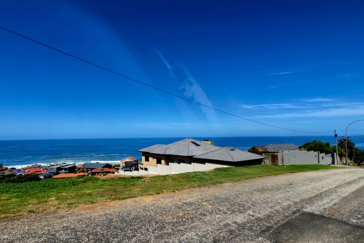 A scenic elevated view overlooking the coastline and ocean, showcasing the property's prime location and expansive sea vistas.