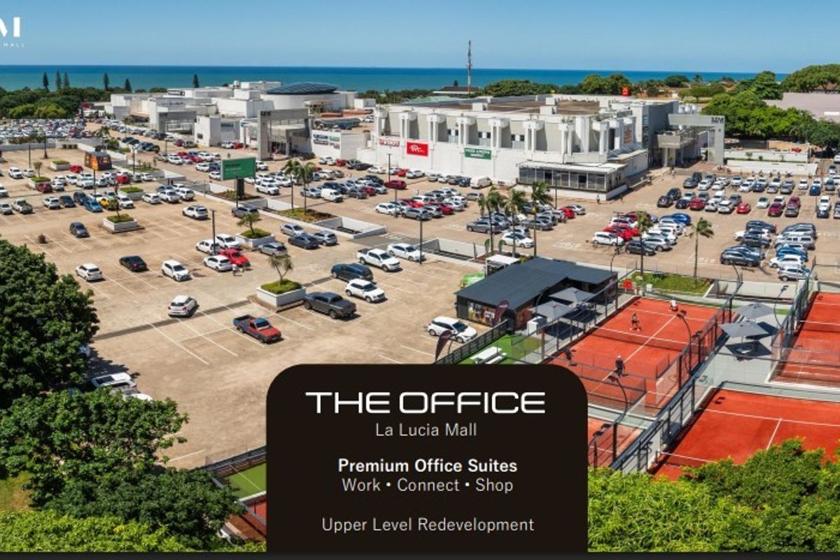 Aerial view of the La Lucia Mall complex featuring extensive parking facilities, commercial office suites, and outdoor tennis courts.
