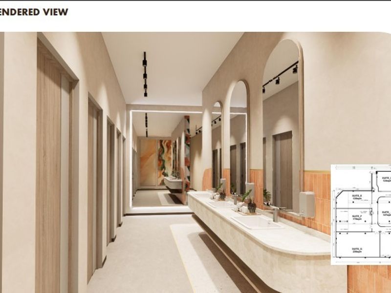 A modern, high-end commercial bathroom rendering featuring a long vanity with integrated sinks, arched mirrors, and contemporary track lighting.
