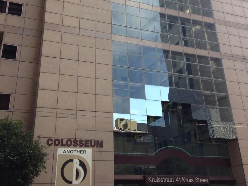 Exterior view of the Colosseum building facade featuring stone cladding and glass curtain walling at 41 Kruis Street.