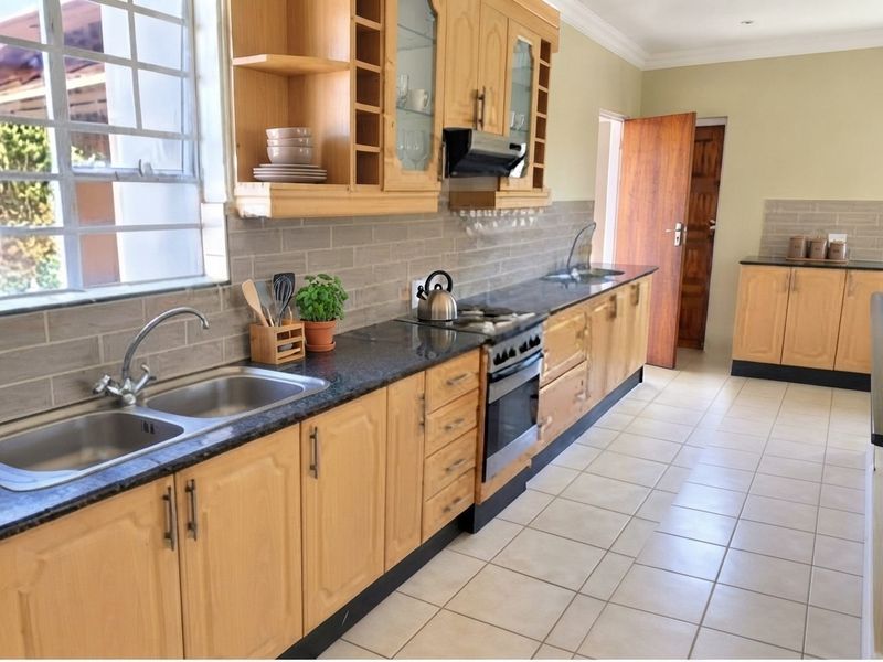 A functional kitchen featuring wooden cabinetry, granite countertops, a double bowl sink, and a tiled backsplash, offering a practical layout for daily meal preparation.