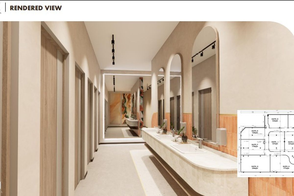 A modern, high-end commercial bathroom rendering featuring a long vanity with integrated sinks, arched mirrors, and contemporary track lighting.
