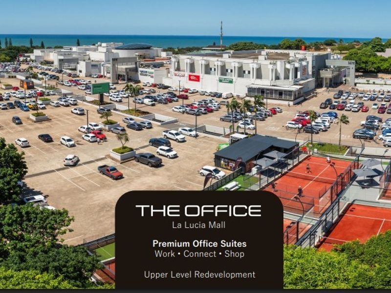 Aerial view of the La Lucia Mall complex featuring extensive parking facilities, commercial office suites, and outdoor tennis courts.