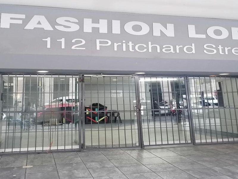 The front entrance of Fashion Lofts at 112 Pritchard Street, featuring a secure metal gate and tiled entryway.