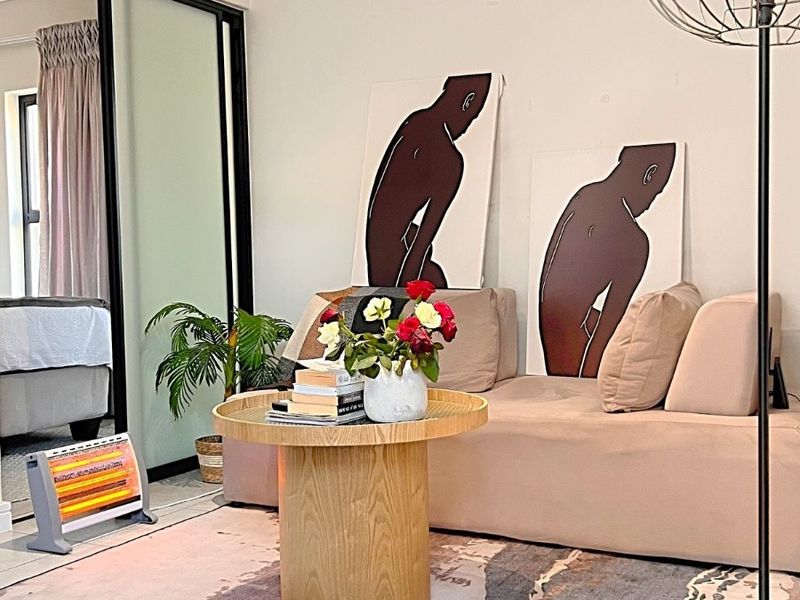 A well-maintained living area featuring tiled flooring and large sliding mirror wardrobe doors, creating a bright and functional space.