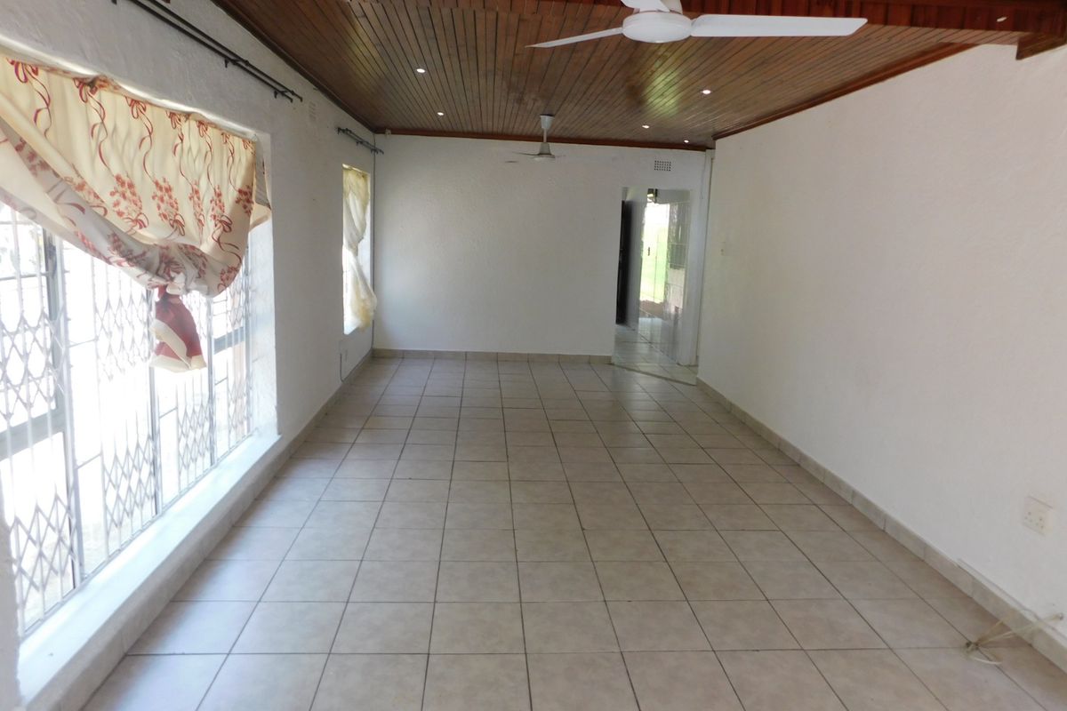 Spacious, empty living area featuring a timber tongue and groove ceiling, recessed lighting, ceiling fans, and ceramic tiled flooring.