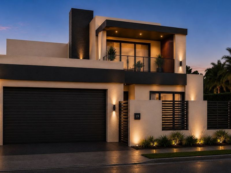 A modern two-story residential facade featuring a double garage, a private upper-level balcony, and integrated architectural lighting at dusk.