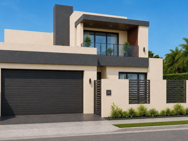 Modern double-story residential facade featuring a sleek garage, private balcony with glass balustrade, and contemporary boundary wall design.