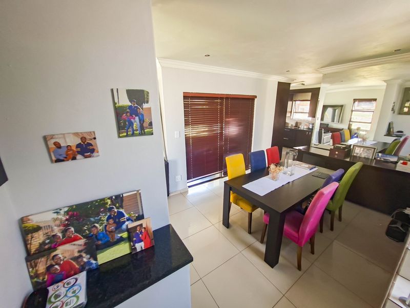 Open-plan living and dining area featuring tiled flooring, recessed lighting, and direct access to the outdoors via sliding glass doors.