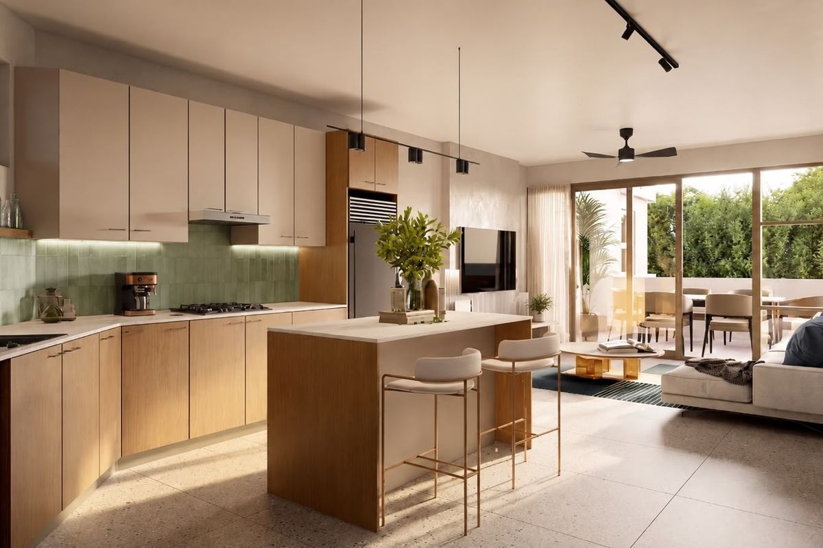 Modern open-plan living area featuring a contemporary kitchen with island, integrated appliances, and seamless flow to an outdoor balcony through large sliding glass doors.