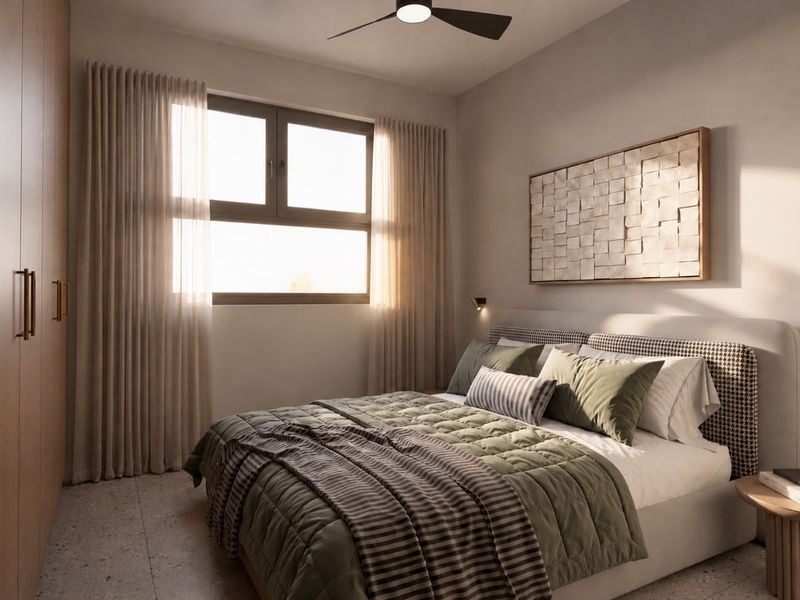 A modern, well-appointed bedroom featuring built-in wardrobes, terrazzo flooring, and a ceiling fan, creating a warm and inviting atmosphere.