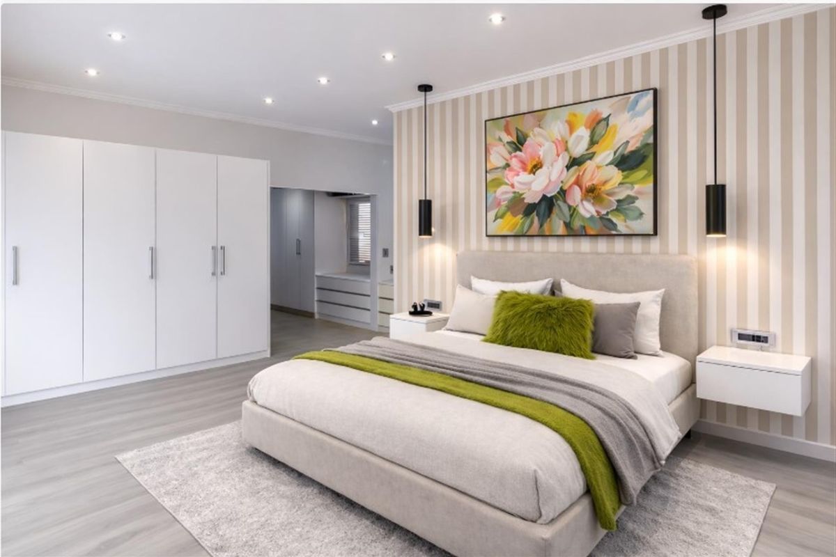 A modern, well-maintained bedroom featuring built-in wardrobes, stylish pendant lighting, recessed downlights, and a feature striped wall.